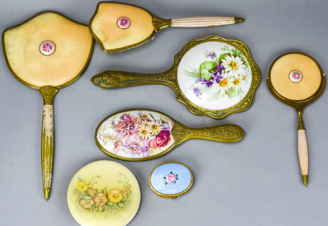 Lot of Vintage Enamel & Metal Vanity Hand Mirrors: Lot of Vintage Enamel & Metal Vanity Hand Mirrors. Includes mixed style vintage hand mirrors, compacts, and hair brush each with enamel and metal construction. Largest measures 13.5 inches x 6 inches.