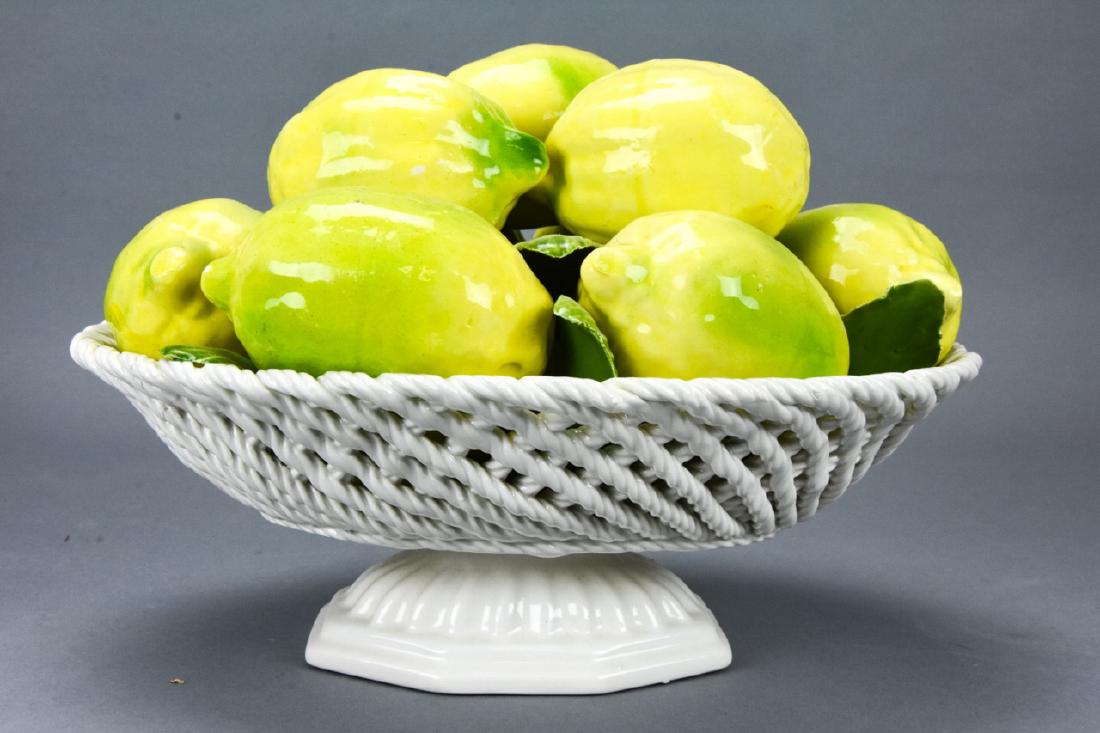 Italian Porcelain Figural Lemon Centerpiece: Italian Porcelain Figural Lemon Centerpiece. Figural porcelain centerpiece of lemons / limes on a reticulated basket. Made in Italy. Measures approximately 7 inches x 9 inches x 7 inches. Property of 