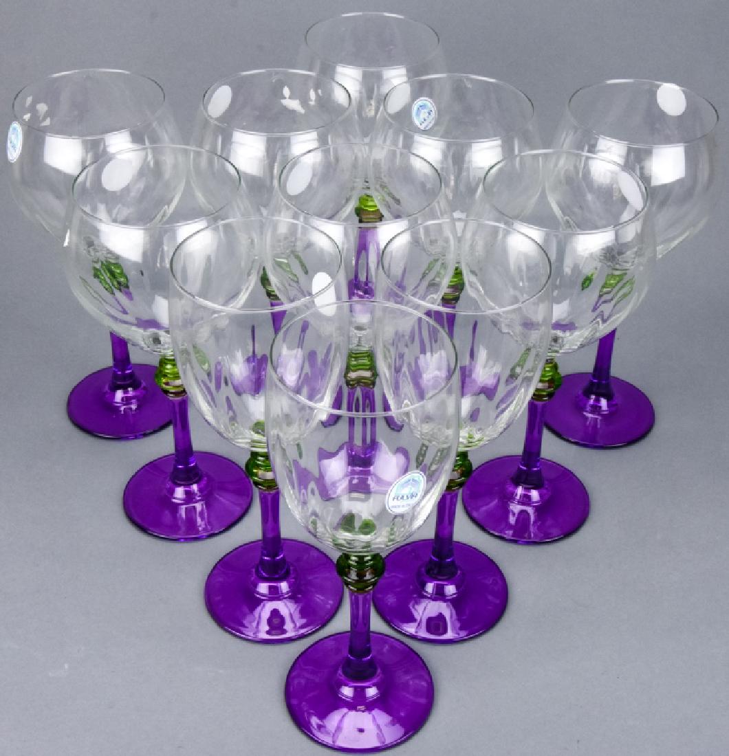 11 Fulvia Italian Art Glass Wine Glasses Goblets: 11 Fulvia Italian Art Glass Wine Glasses / Goblets. Varying sizes. Each has a purple and green glass decorative stem. Larger size measures 8 inches x 2.75 inches in diameter. Property of an Irvington,