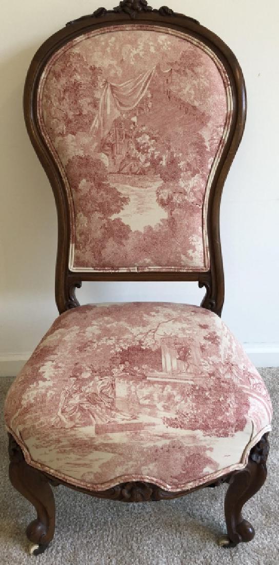 Edwardian Upholstered Low Seated Parlor Chair: Edwardian Upholstered Low Seated Parlor Chair. Hand carved and toile upholstered. The chair is on casters. 39 inches x 19 inches x 24 inches