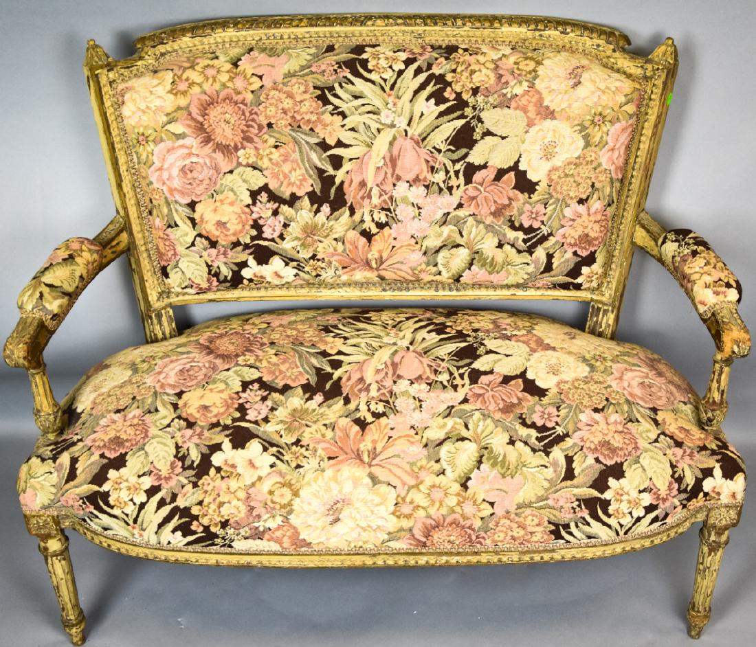 Louis XVI Style Tapestry Upholstered Settee: Louis XVI Style Tapestry Upholstered Settee. Louis XVI style settee with a carved wood frame and tapestry style upholstery. 34 inches x 41 inches x 19 inches.