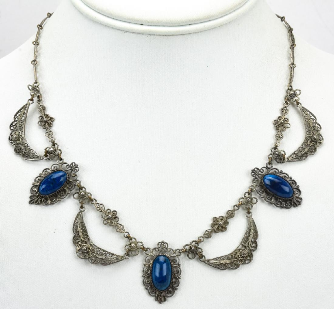 Estate Silver Filigree Cabochon Sodalite Necklace: Estate Silver Filigree Cabochon Sodalite Necklace. Measures 17 inches in length.
