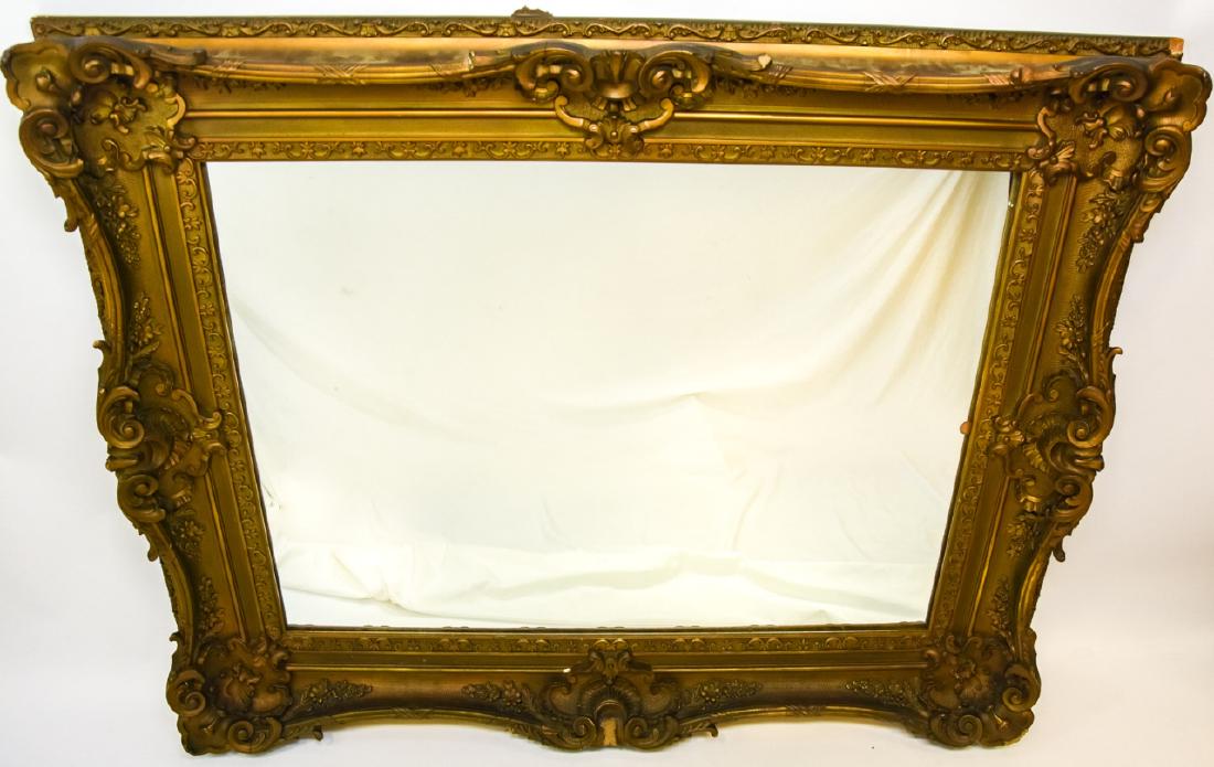 French Rococo Style Gilt Carved Mirror: French Rococo Style Gilt Carved Mirror. Measures 43 inches x 52 inches x 5 inches.