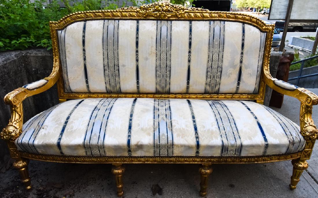 Louis XVI Style Gilt & Custom Upholstered Settee: Louis XVI Style Gilt & Custom Upholstered Settee. This lot features a Louis XVI style settee with a carved wood and gilt frame and custom upholstery in blue, cream and white colorways and brass nail h