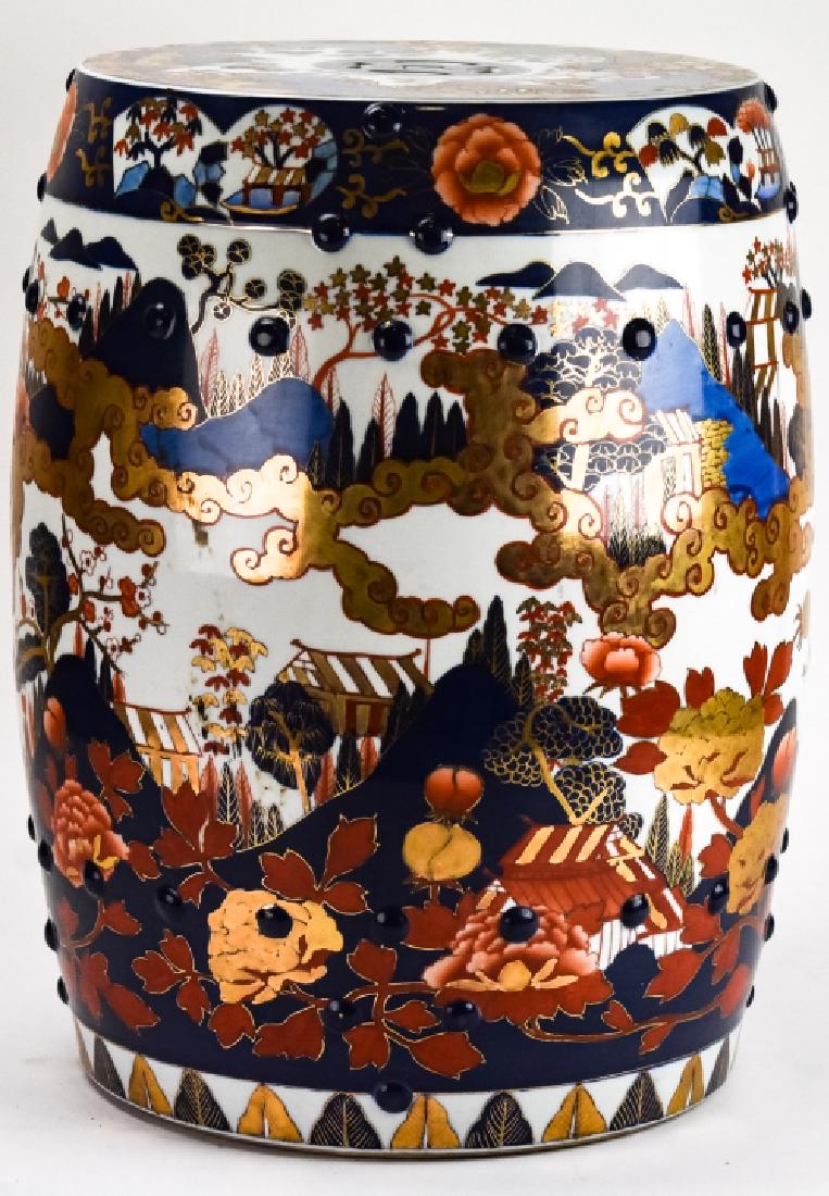 Japanese Imari Hand Painted Porcelain Garden Stool: Japanese Imari Hand Painted Porcelain Garden Stool. Japanese Imari garden stool featuring hand painted motifs of clouds, mountains, trees and cottages in gold, blue and red color ways.