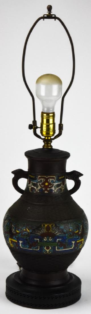 Chinese Hand Painted Urn Form Metal Table Lamp: Chinese Hand Painted Urn Form Metal Table Lamp. Chinese urn form table lamp with hand painted motifs and figural handles. 26.5 inches x 7 inches in diameter.