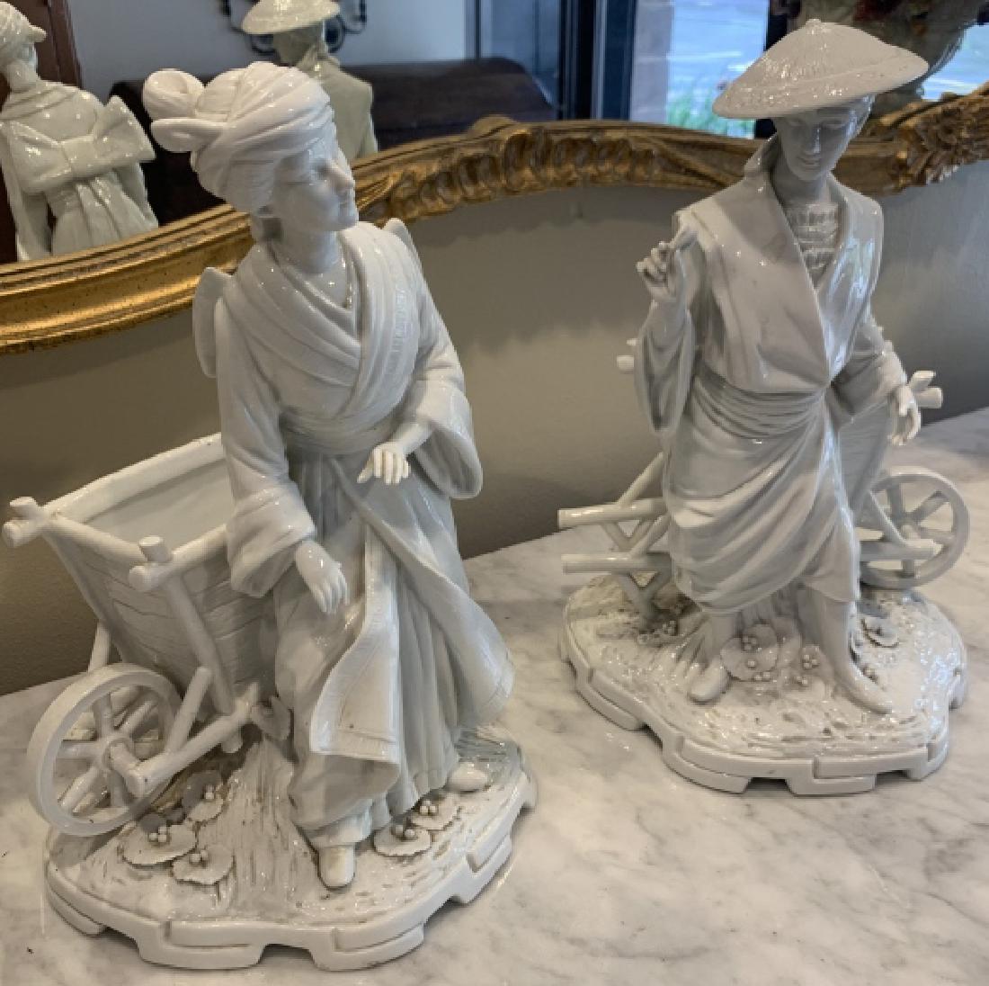 Pair Chines Blanc de Chine Porcelain Statues: Pair Chines Blanc de Chine Porcelain Statues. Each features a figure with a cart. Both art partially marked and incised on the bottom. 13.5 inches x 9 inches x 8 inches.