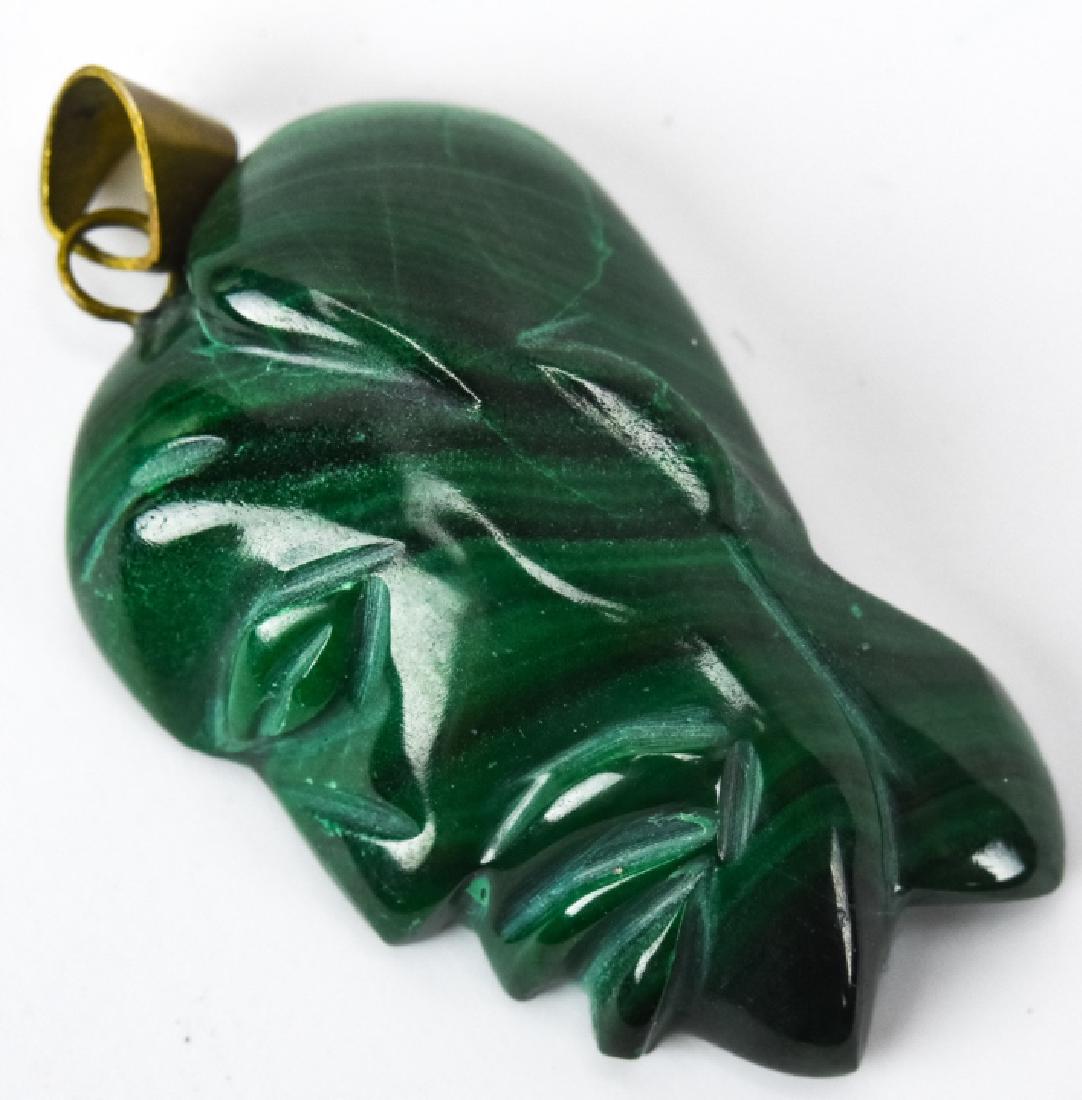 Carved Malachite African Motif Necklace Pendant: Carved Malachite African Motif Necklace Pendant. Measures 1.25 inches in length.