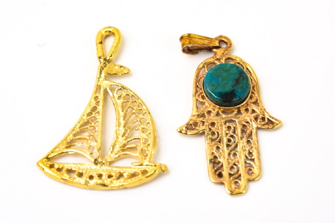 2 14kt Yellow Gold Filigree Charms: 2 14kt Yellow Gold Filigree Charms. Sail boat and hamsa hand. Hamsa measures just under 1.5 inches in length.