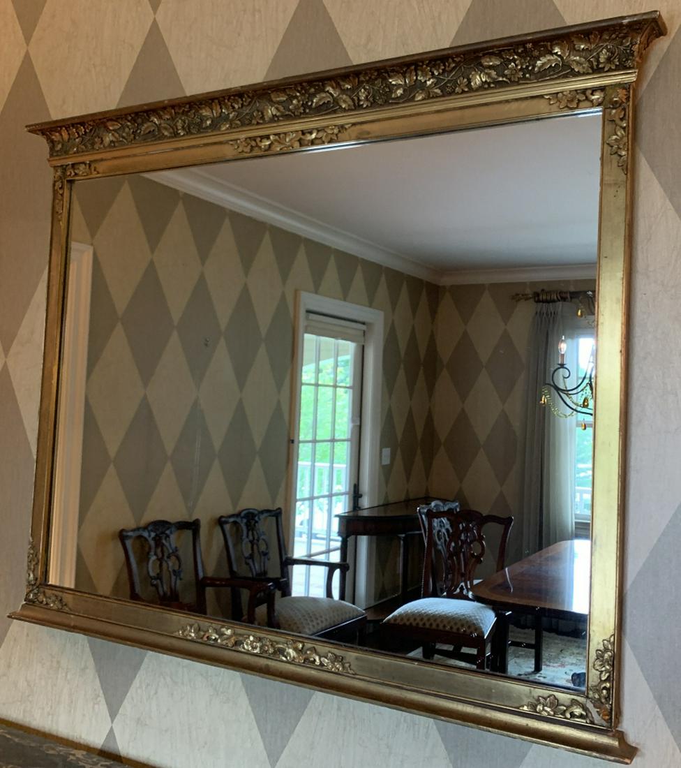 Antique Gilt & Hand Carved Mirror: Antique Gilt & Hand Carved Mirror. Featuring a floral motif. 36 inches x 44 inches.