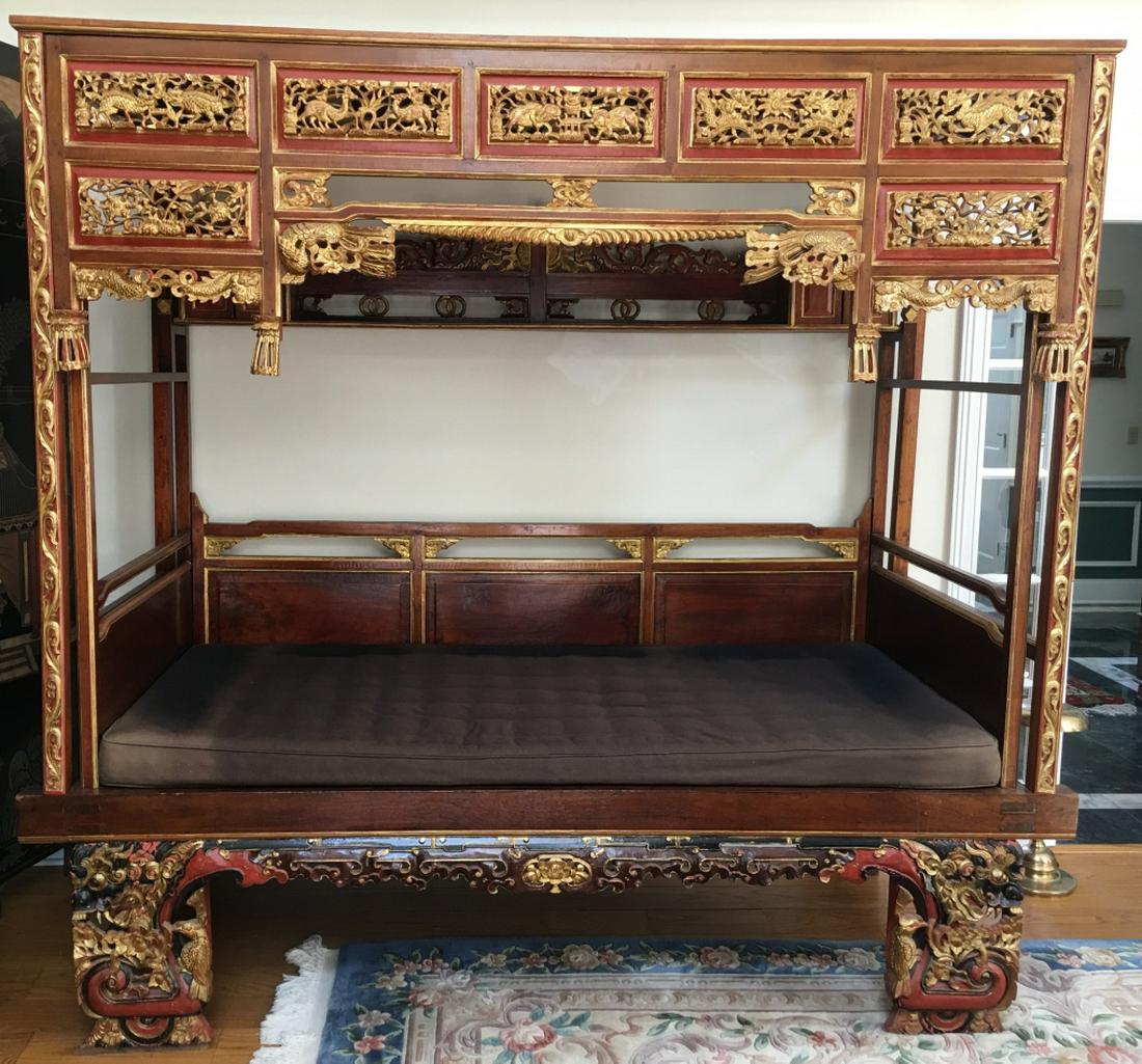 Impressive Antique Chinese Carved Opium Daybed: Impressive Antique Chinese Carved Opium Daybed. This lot features an impressive and heavily carved Chinese opium / wedding daybed. All over ornate carvings of animals and dragons with gilt details. Wi