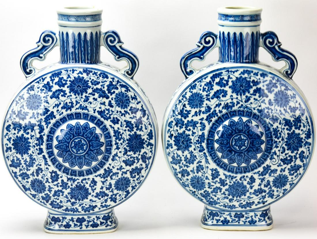 Pair Chinese Blue & White Porcelain Moon Flasks: Pair Chinese Blue & White Porcelain Moon Flasks. Each with handles and a floral motif. Signed.18.75 inches x 12.5 inches x 4 inches.