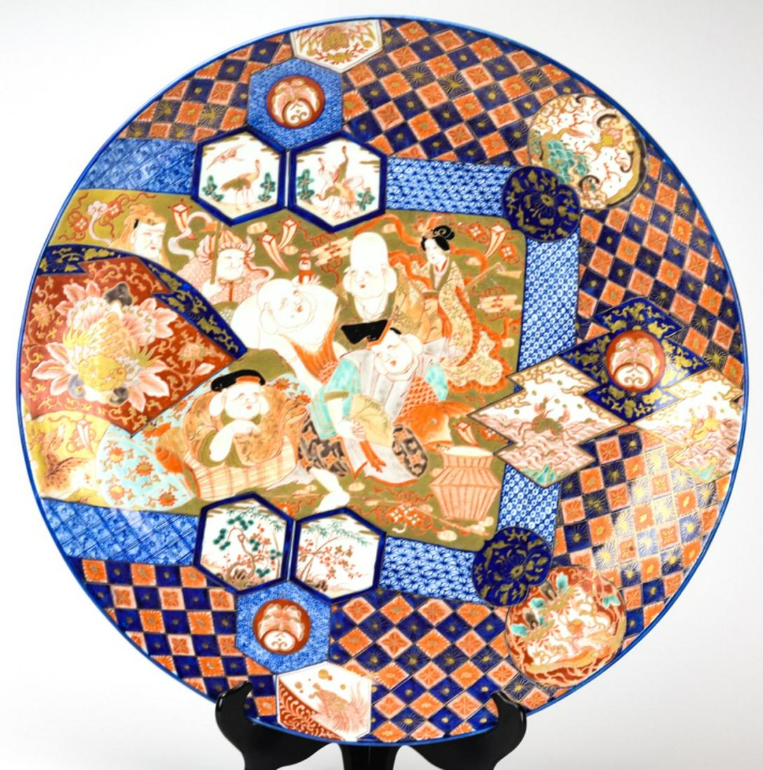 Antique 19th C Large Japanese Imari Charger: Antique 19th C Large Japanese Imari Charger. This lot features an antique 19th century Japanese Imari porcelain charger. Hand painted with a scene of Gods on a picnic and gilt. Circa 1840. 24 inches i