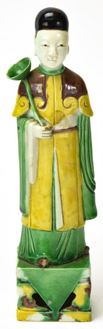 Chinese Spinach & Egg Glazed Scholar Statue: Chinese Spinach & Egg Glazed Scholar Statue. Chinese spinach and egg yolk style glazed porcelain figural statue of a young scholar. Reticulated base. 10 inches x 2.5 inches x 1.75 inches.