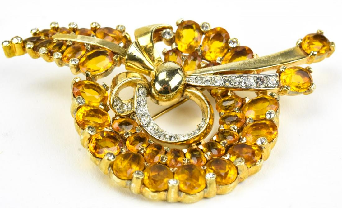 Vintage Mazer Retro Rhinestone Brooch: Vintage Mazer Retro Rhinestone Brooch. Gilt metal set with clear and citrine tone rhinestones. Signed on back. Measures 3 inches in length.