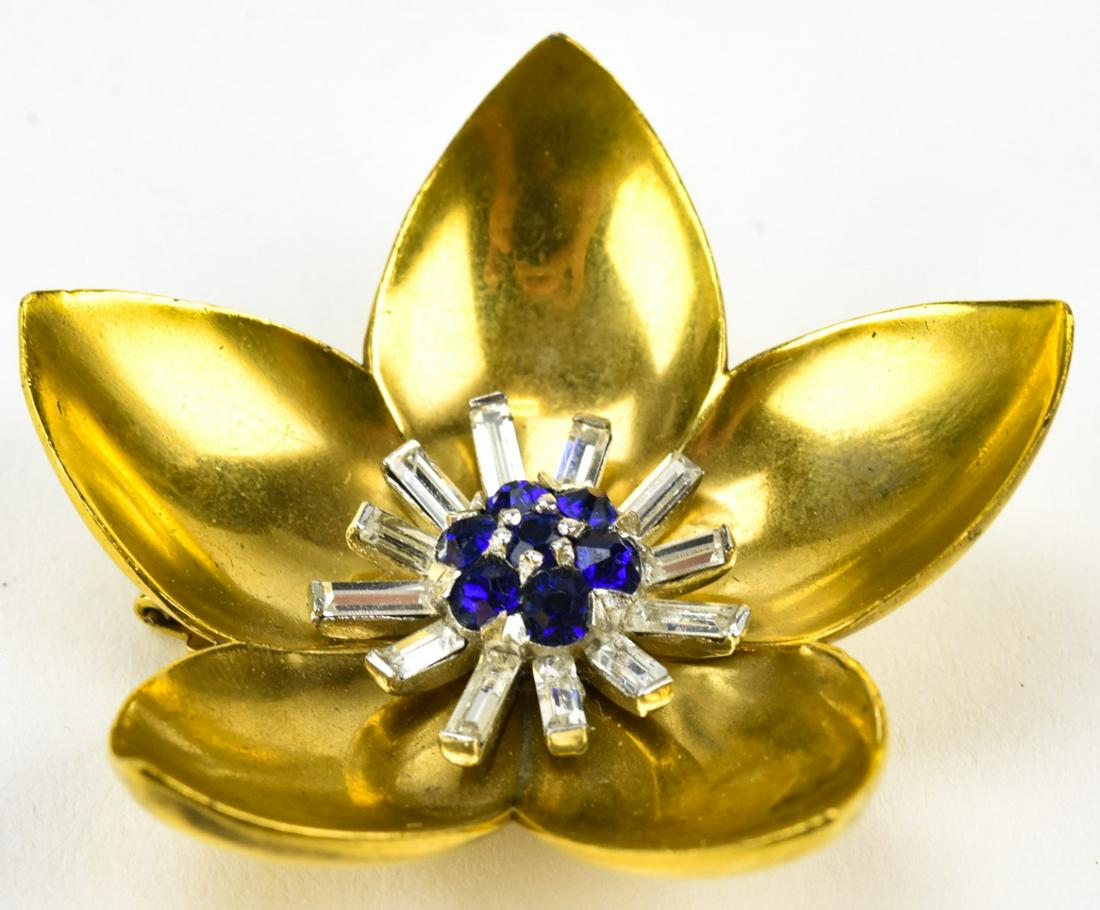 Vintage 1940 Mazer Gilt Floral Clip: Vintage 1940 Mazer Gilt Floral Clip. Set with sapphire tone and clear rhinestones. Measures 2.5 inches in diameter.