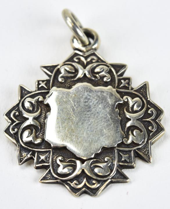 Antique English Sterling Silver Badge Form Pendant: Antique English Sterling Silver Badge Form Pendant. With hallmarks on back. 1 inch in length.