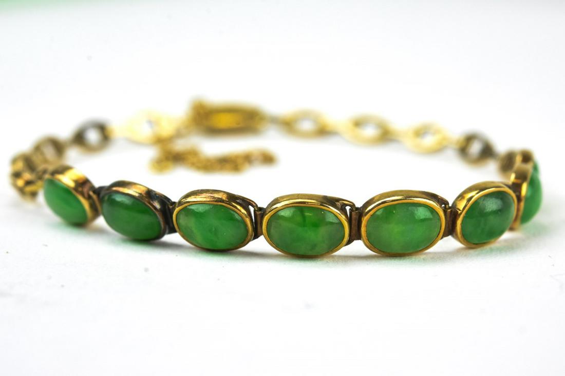 Estate 14kt Yellow Gold & Jade Cabochon Bracelet: Estate 14kt Yellow Gold & Jade Cabochon Bracelet. Set with 8 oval cut jade cabochons, Chinese hallmark on clasp. Safety chain. Measures 6 inches in length.
