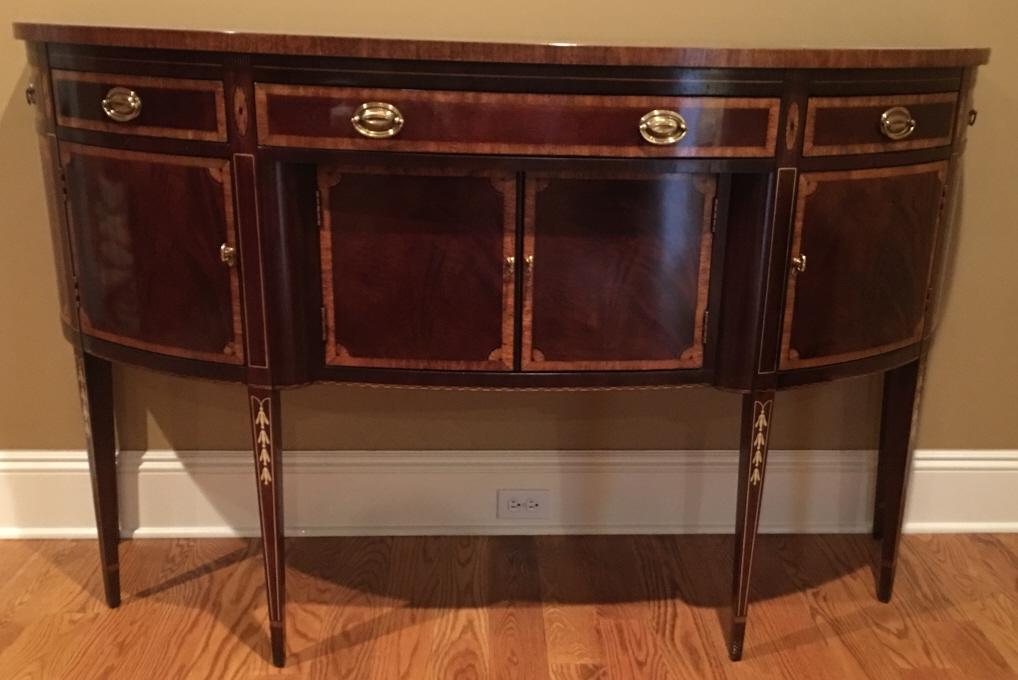 Hickory White Hepplewhite Style Inlaid Sideboard: Hickory White Hepplewhite Style Inlaid Sideboard. With marquetry and veneer inlay, banding, and tapered legs. Brass hardware, three drawers and three cabinets. 40 inches x 65 inches x 22 inches.