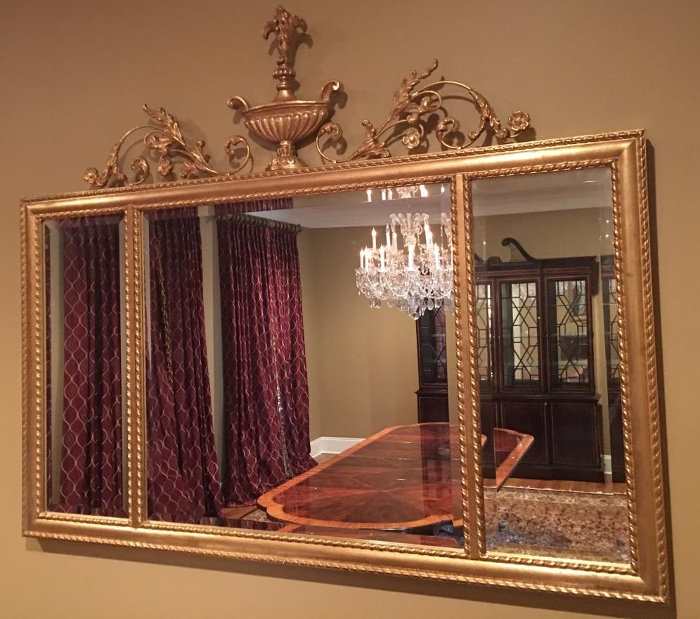 French Rococo Style Three Panel Beveled Mirror: French Rococo Style Three Panel Beveled Mirror. With urn and floral motif at top. Gilt frame. 42 inches x 51 inches.