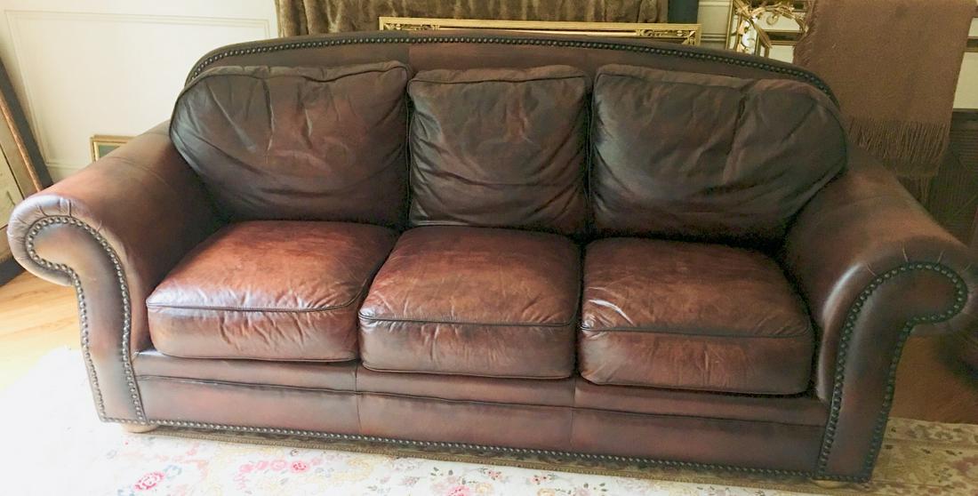 Chesterfield Style Leather Sofa / Couch: Chesterfield Style Leather Sofa / Couch. With brown leather upholstery, brass nail head trim and rolled arms. 38 inches x 91 inches x 34 inches.
