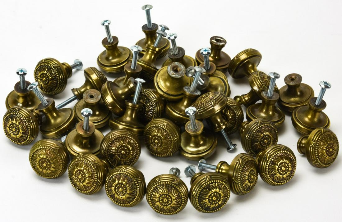 40 Solid Rubbed Brass Cabinet Pulls: 40 Solid Rubbed Brass Cabinet Pulls. Each with molded neo classical pattern. 1 inch in diameter.