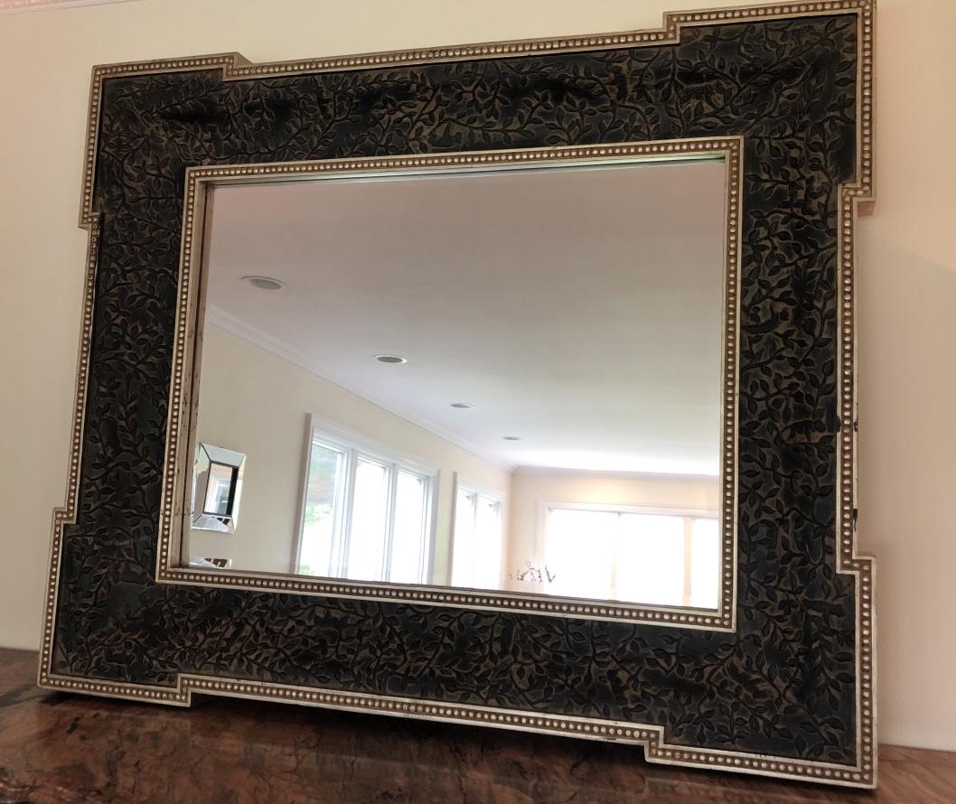 Contemporary Large Jacobean Style Carved Mirror: Contemporary Oversized Jacobean Style Carved Mirror. Very large, heavily framed and heavily carved wall mirror with step back frame. Jungle plant and animal motif. 47 inches x 57 inches x 4 inches.