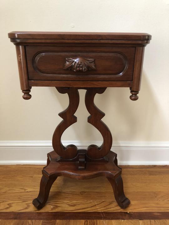 Cottage Victorian Walnut Carved Pedestal Table: Cottage Victorian Black Walnut Carved Pedestal Side Table. Side table with heavily carved arched base and drawer handle with leaf and berry motif. From the Davis Cabinet Company, Nashville, Tennessee.