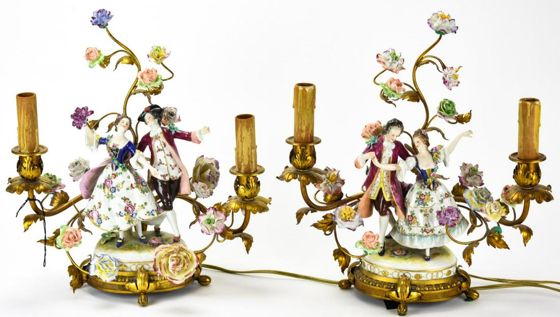 2 Antique Volkstedt Signed Porcelain + Tole Lamps: Pair Antique Volkstedt Signed Porcelain + Tole Lamps. Pair of matching lamps that feature Volkstedt porcelain figures mounted on gilded ormolu and tole base. Tole vines covered in porcelain flowers su