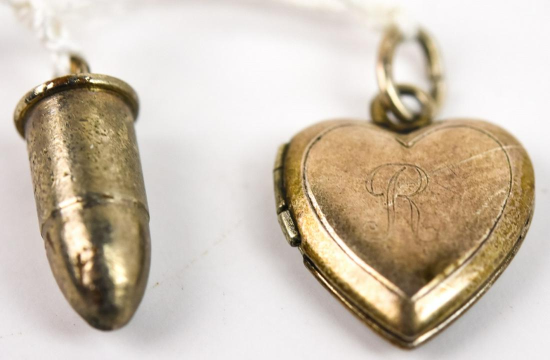 Vintage Sterling Silver Bullet & Heart Locket: Vintage Sterling Silver Bullet & Heart Locket. Charms or necklace pendant. Bullet measures 1/2 an inch in length.