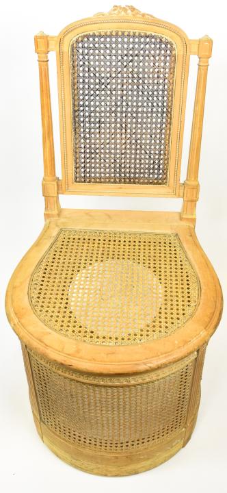 Louis XVI Style Caned Commode Chair: Louis XVI Style Caned Commode Chair. Light wood and caned commode chair with lift top seat. 30 1/2 inches x19 1/2 inches x 20 inches.