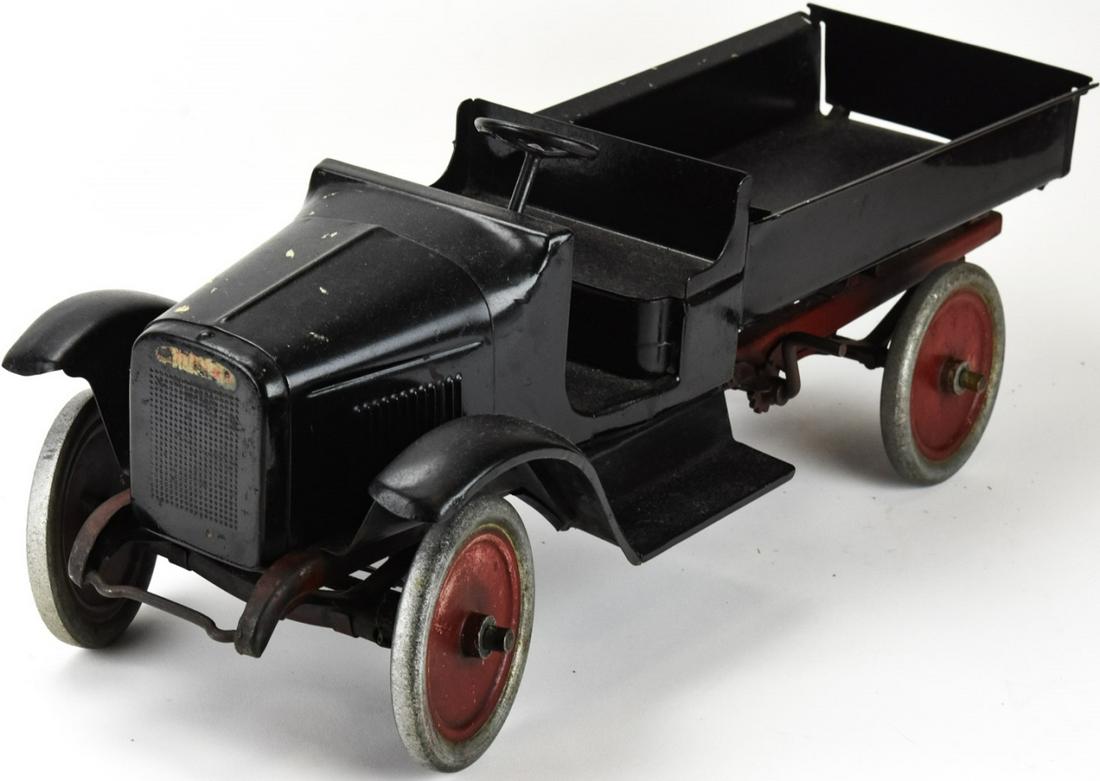 Buddy L Quality Toys Pressed Steel Dump Truck: Buddy L Quality Toys Pressed Steel Dump Truck. Painted red and black. With label on interior front. 7 inches x 24 inches x 8 inches.
