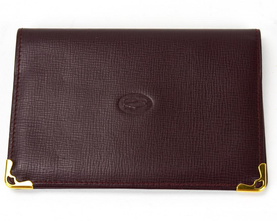 Cartier Paris Red Leather Passport Cover: Cartier Paris Red Leather Passport Cover. Front is embossed with the Cartier logo, each corner features polished brass details. 5 inches x 3.5 inches.