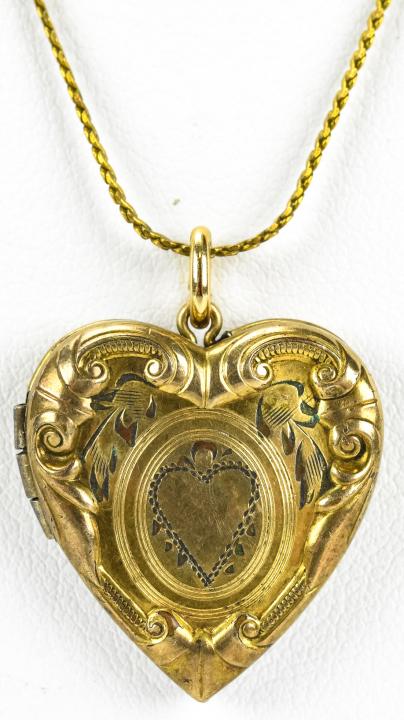Antique Gold Filled Heart Form Locket: Antique Gold Filled Heart Form Locket. Chain measures 18 inches in length.