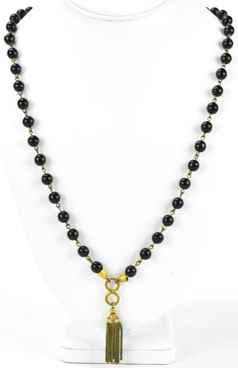 Antique Garnet Glass Necklace W Tassel: Antique Garnet Glass Necklace W Tassel. Measures 31 inches in length.
