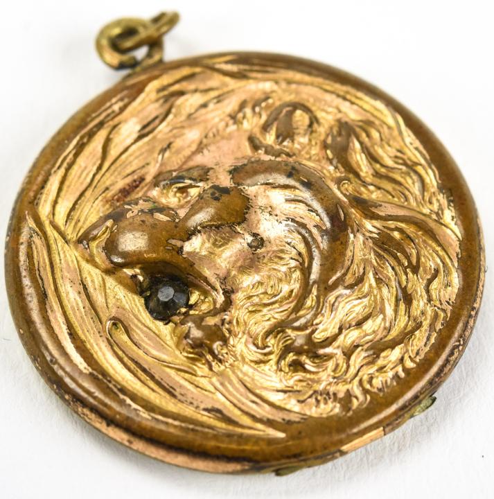 Antique 19th C Gold Filled Locket Pendant: Antique 19th C Gold Filled Locket Pendant. Repousse lion head on front. Measures 1.25 inches.