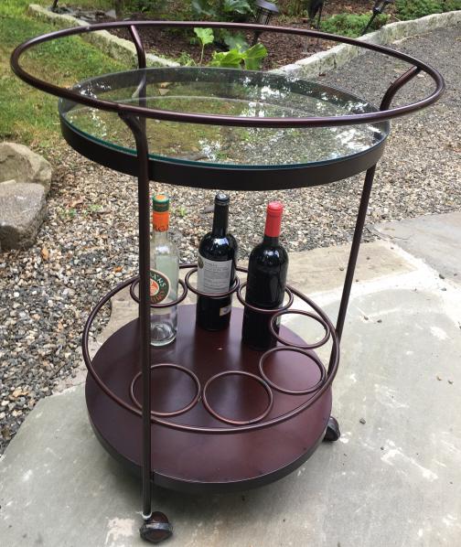 Contemporary Wine / Bar Table: Contemporary Wine / Bar Table. Metal bar cart with glass top and three bottle compartments at base. On wheels. 30 inches x 22 inches.