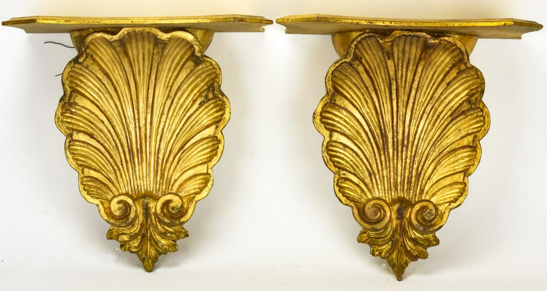 Pair Carved Rococo Rocaille Shell Gilded Brackets: Pair Carved Rococo Rocaille Shell Gilded Brackets. Vintage gilt carved wall shelves / brackets in rocaille shell form that are stamped Made in Italy. 13 inches x 14 inches x 7 inches