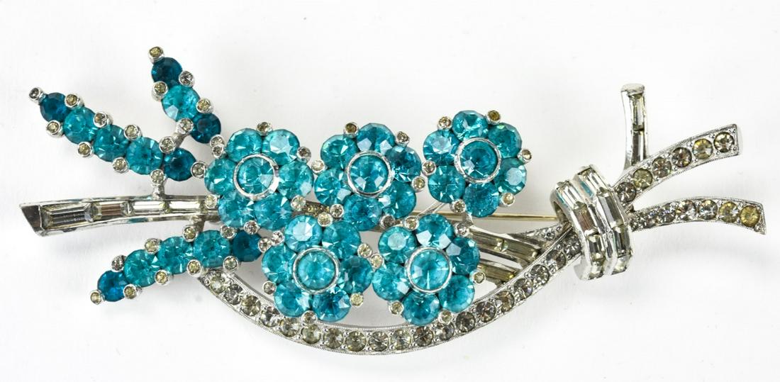 Pennino C 1935 Bold Retro Floral Spray Brooch: Pennino C 1935 Bold Retro Floral Spray Brooch. Signed Pennino circa 1935 rhodium plated floral spray motif brooch set with aqua paste. 1.5 inches x 4.25 inches.