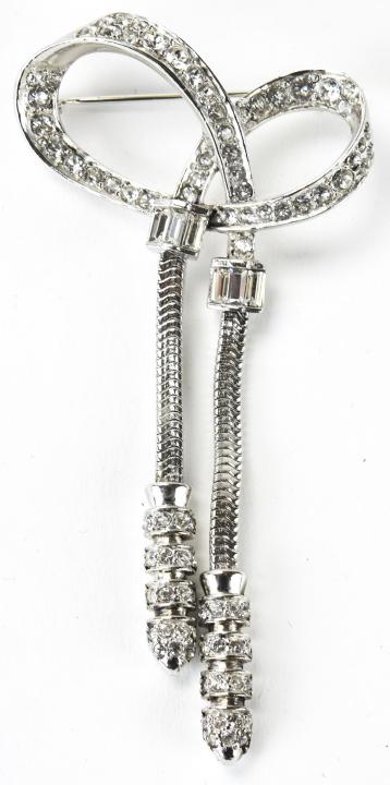 Marcel Boucher Circa 1940 Bow Brooch: Marcel Boucher Circa 1940 Bow Brooch. Retro style bow design brooch with snake chains and clear paste. Signed MB for Marcel Boucher. Measures 3.25 inches x just over 1.5 inches.