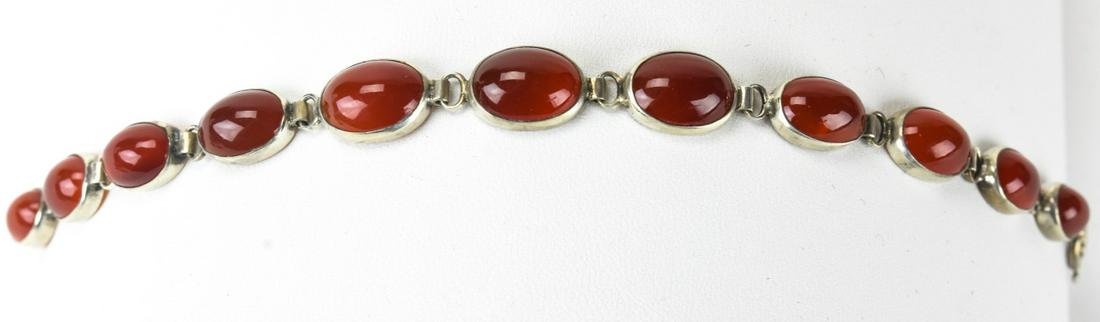 Sterling Silver & Carnelian Cabochon Bracelet: Sterling Silver & Carnelian Cabochon Bracelet. Natural graduated carnelian cabochons in sterling bezel settings. Measures 7 inches in length.
