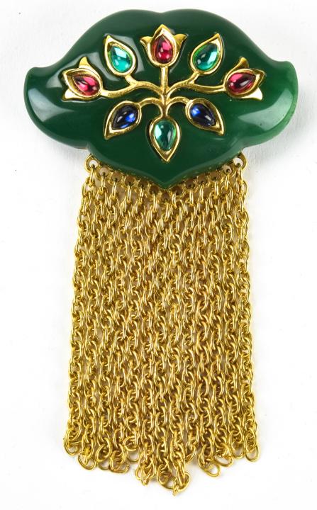 Trifari Circa 1975 Mughal Style Brooch: Trifari Circa 1975 Mughal Style Brooch. With chunky green acrylic top set with multi colored teardrop form cabochons and gilt metal fringe bottom. Signed on back. Measures 4 inches x 2.25 inches.