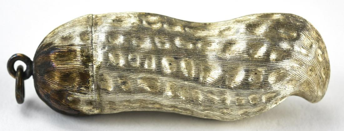 Sterling Silver Figural Peanut Pill Box Pendant: Sterling Silver Figural Peanut Pill Box Pendant. Hallmarked on interior. Figural peanut pill box with bail. Measures 2.5 inches in length with bail. Weighs approximately .585 standard ounces.