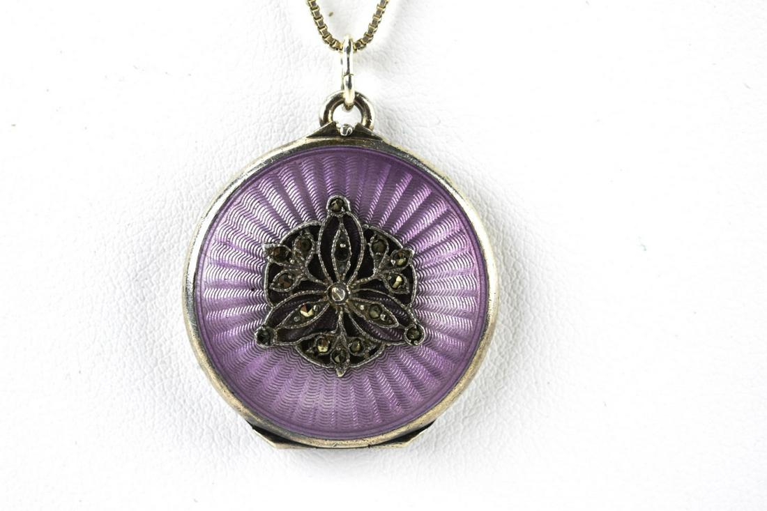 Antique European Sterling Enamel Marcasite Locket: Antique European Sterling Enamel Marcasite Locket. Antique European locket with purple guilloche enamel and marcasaite design at front on sterling silver chain. Chain measures 18 inches, locket measur