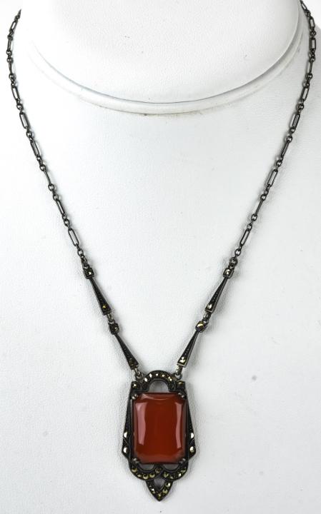 1930s Deco Sterling Carnelian & Marcasite Necklace: 1930s Deco Sterling Carnelian & Marcasite Necklace. Sterling silver necklace with carnelian pendant and marcasite accents. Hallmarked and signed Nov-e-Line. Measures 25 inches plus pendant.