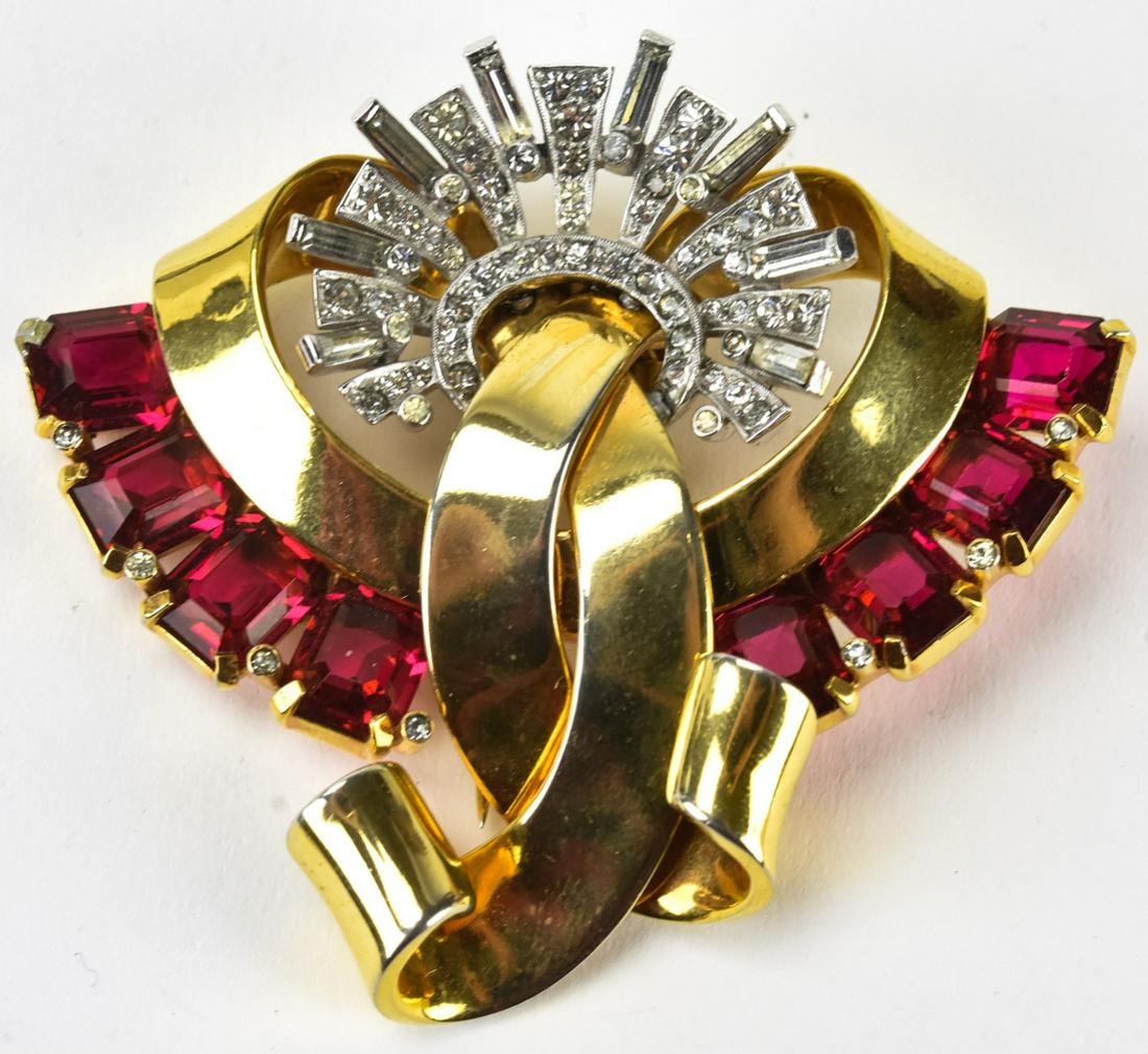 Impressive Mazer C 1940 Retro Gilt Ribbon Brooch: Impressive Mazer C 1940 Retro Gilt Ribbon Brooch. Gilt metal ribbon design brooch or clip with clear paste fan top and prong set ruby crystals. Measures 2.25 inches x 2 7/8 inches. Signed on back.