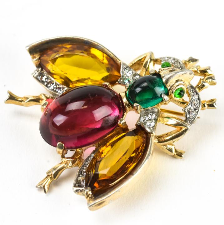 Trifari C 1945 Sterling Jeweled Fly Bug Brooch: Trifari C 1945 Sterling Jeweled Fly Bug Brooch. Trifari sterling brooch with green and red cabochons, citrine and clear rhinestones. Signed on back. Patent number 31268. Measures 1.75 inches x 1.5 inc