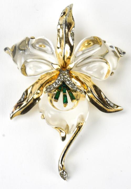 Trifari Sterling Jelly Belly Orchid Brooch: Trifari Sterling Jelly Belly Orchid Brooch. With clear and emerald rhinestones. Patent number 138653. Measures 3.25 inches x 2.25 inches.