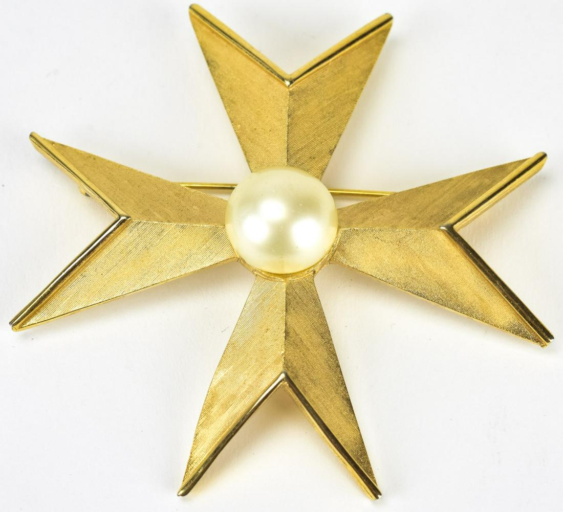 Trifari 1970 Gilt Metal Pearl Maltese Cross Brooch: Trifari 1970 Gilt Metal Pearl Maltese Cross Brooch. Trifari circa 1970 gilt metal and faux pearl center Maltese cross design brooch. Measures 2.75 inches.
