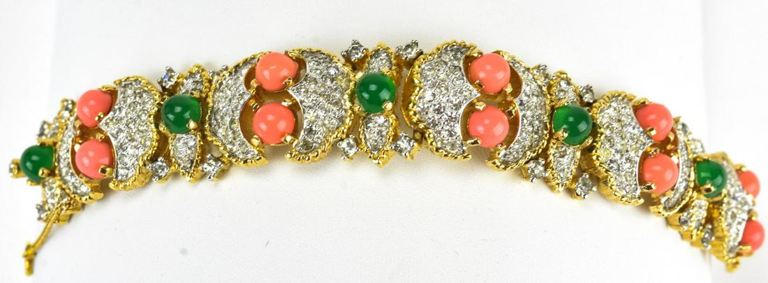 Jomaz 1970s Faux Coral Jade & Rhinestone Bracelet: Jomaz 1970s Faux Coral Jade & Rhinestone Bracelet. Gilt metal bracelet with pave rhinestones, faux coral cabochons and faux jade cabochons. Signed Jomaz. Measures 6.5 inches.